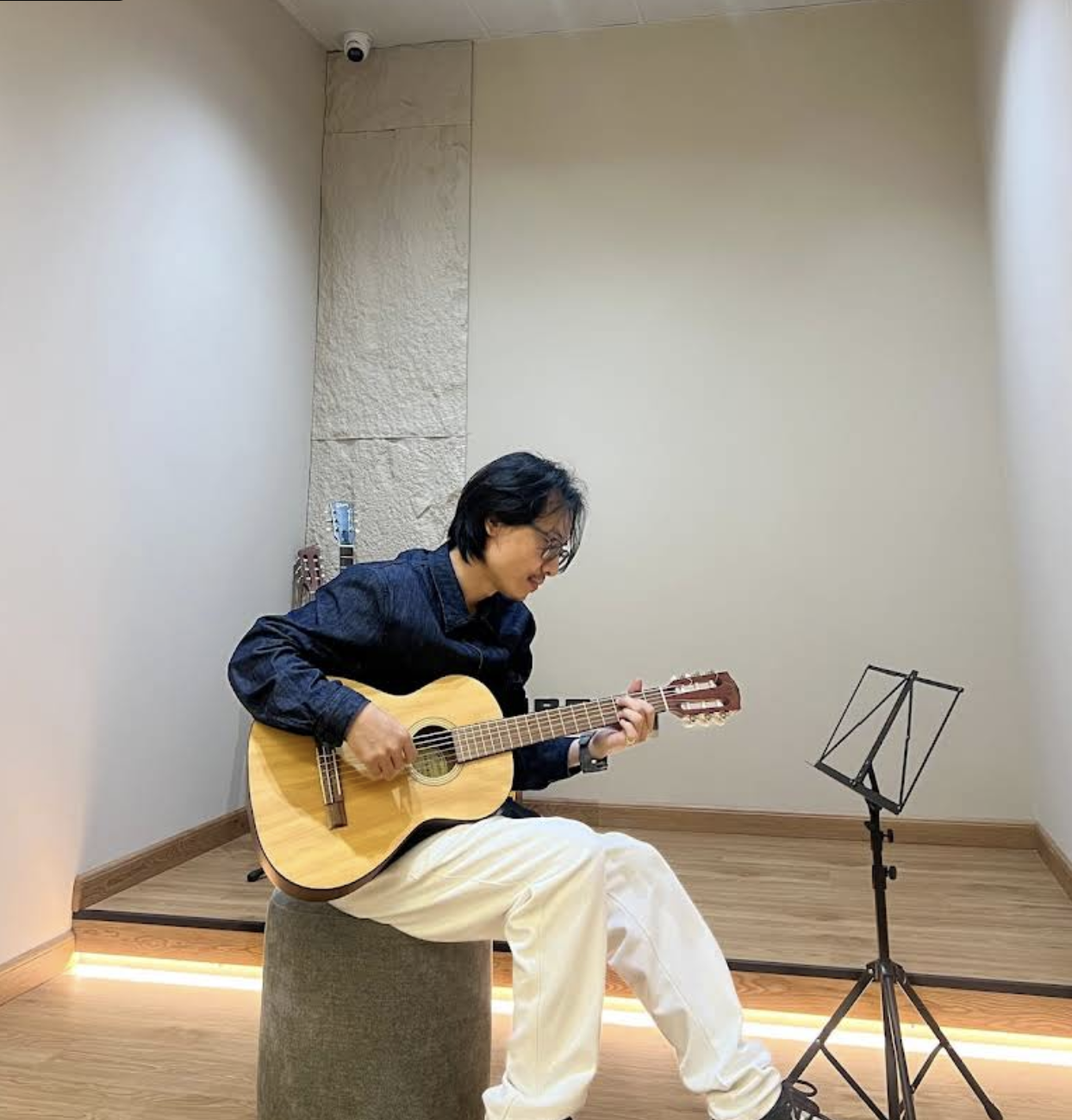 Instructor teaching guitar